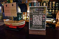 A sign with a QR code that links to a drinks menu