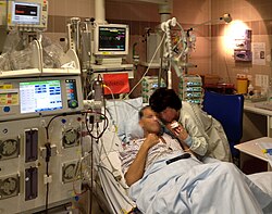 A patient of an intensive care unit in a German hospital in 2015 who had a nearly complete dysfunction of the kidneys due to a severe sepsis. The hemodialysis had to be carried out with a portable machine (left) on rollers near the bed, because the patient was too weak to leave the bed. Without this treatment, he would not have survived.
