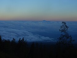 View of Mount Rinjani from Mount Tambora. Viewing distance is 165 kilometres (103 mi).