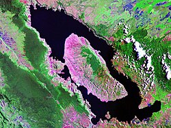 Landsat image of Lake Toba, on the island of Sumatra, Indonesia (100 km/62 mi long and 30 km/19 mi wide, one of the world's largest calderas). A resurgent dome formed the island of Samosir.