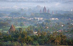 Prāsāda (towers) of Sajiwan and Prambanan viewed from Ratu Boko hill, the area in Prambanan Plain was the location of the Mataram capital.