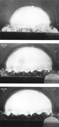 Shock wave propagating into a stationary medium, ahead of the fireball of an explosion. The shock is made visible by the shadow effect (Trinity explosion).