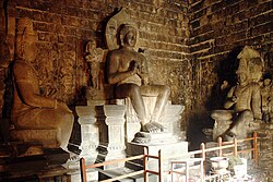 The statue of Dhyani Buddha Vairocana, Avalokitesvara, and Vajrapani inside the Mendut temple