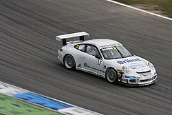 A car is moving in high speed during a championship, with respect to the ground the position is changing according to time hence the car is in relative motion