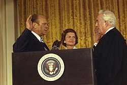 Vice President Gerald Ford is sworn in as the 38th President of the United States by Chief Justice Warren Burger in the East Room at the White House as Betty Ford looks on.