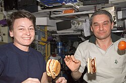 Astronauts making and eating hamburgers on board the ISS, 2002[130]