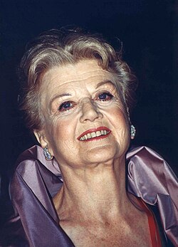 An older white woman looking towards the viewer.