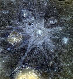 Multispectral image of Bek crater and its ray system on the surface of Mercury, acquired by MESSENGER, combining images at wavelengths of 996, 748, 433 nm. The bright yellow patches in other parts of the image are hollows.