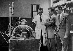 Dr. John P. Merrill (left) explains the workings of a then-new machine called an artificial kidney to Richard Herrick (middle) and his brother Ronald (right). The Herrick twin brothers were the subjects of the world's first successful kidney transplant, Ronald being the donor.