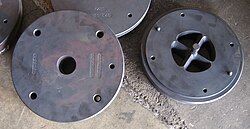 Two-piece aluminum extrusion die set (parts shown separated.) The male part (at right) is for forming the internal cavity in the resulting round tube extrusion.
