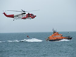 A search and rescue demonstration by an Irish Coast Guard Sikorsky S-61 helicopter and a RNLI lifeboat.