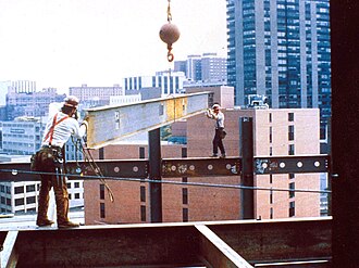 Construction workers at height without appropriate safety equipment