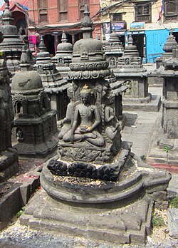 A linga-yoni in Nepal carved with four seated Buddhas