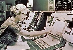Roman sits at the control console for the Orbiting Astronomical Observatory satellite, launched in 1972 and nicknamed Copernicus. This is a publicity picture; she never actually worked in the Goddard control room.[31]