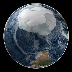 A composite image of Earth with an opaque cloud cover, making the different types of surface discernible: Earth's surface dominating Ocean (blue), Africa with lush (green) to dry (brown) land and Earth's polar ice in the form of Antarctic sea ice (grey) covering the Antarctic or Southern Ocean and the Antarctic ice sheet (white) covering Antarctica.