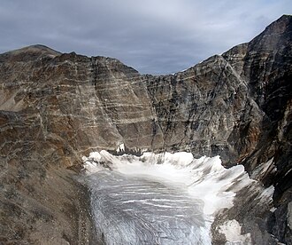 Proterozoic pegmatite swarm in the headwall of the cirque of a small mountain glacier, northeastern Baffin Island, Nunavut