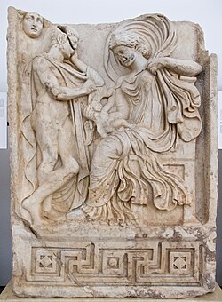 A Venus-Aphrodite velificans holding an infant, probably Aeneas,[v] as Anchises and Luna-Selene look on (Roman-era relief from Aphrodisias)
