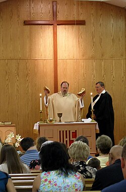United Methodist minister breaking bread during a Communion service