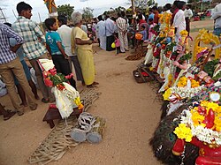 Poturaju standing in front of statues of the Pandavas in a village of Chittoor district, Andhra Pradesh