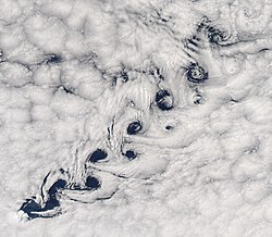 Satellite image of a diagonal pattern of swirling clouds