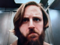Dan O'Bannon in Dark Star, about to tranquilize a troublesome alien.
