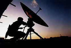 Soldier adjusting a small SATCOM ground terminal to Skynet in 2000