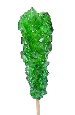 When sugar is supersaturated in water, nucleation will occur, allowing sugar molecules to stick together and form large crystal structures.