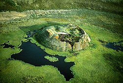 Collapsed pingo in the Mackenzie Delta with thick injection ice. The outline of the previously drained lake can be seen. August 8, 1987.
