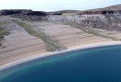 This layered beach at Bathurst Inlet, Nunavut is an example of post-glacial rebound after the last Ice Age. Little to no tide helped to form its layer-cake look. Isostatic rebound is still underway here.