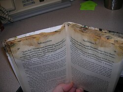 Photo of a book damaged by being inadvertently left for some time in close proximity to a banana in a closed backpack.[24]