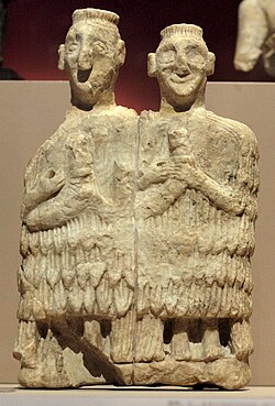"Couple of musicians". Alabaster statuette, discovered at Mari, in the priests' chamber of the Temple of Inanna. Mid 3rd millennium B.C. Musée du Louvre, Paris.