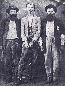 A handcuffed William Longley (center)