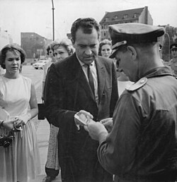 Nixon shows his papers to an East German officer as he crosses between the sectors of divided Berlin in July 1963