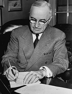 President Truman signing a proclamation declaring a national emergency and authorizing US entry into the Korean War