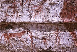 Detail of the mural showing the hind part of the aurochs, a deer and hunters