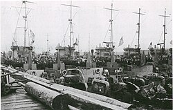 The U.S. flag is lowered aboard LCI(L)s as the U.S. Navy decommissions them for immediate transfer to the Soviet Union, at Cold Bay,on 9 June 1945.[17]