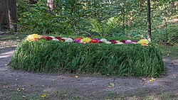 Tolstoy's grave with flowers at Yasnaya Polyana