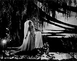 Lillian Gish posed as "The Lily Maid of Shadows" (a line from Tennyson's "Lancelot and Elaine") in a publicity photo for the silent film Way Down East (1920)