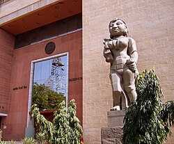 Reserve Bank of India headquarters, Delhi entrance with a yakshini sculpture (c. 1960) depicting "Prosperity through agriculture".[14]
