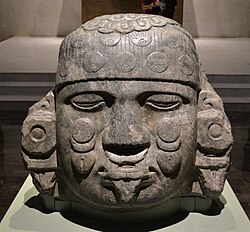 Head of Coyolxāuhqui; c. 1500; diorite; 80 cm × 80 cm × 65 cm (31 in × 31 in × 26 in); National Museum of Anthropology (Mexico City). As usual, she is shown decapitated and with closed eyelids, as her brother, Huitzilopochtli, beheaded her.