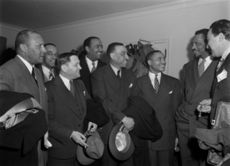 Members of an anti-color line delegation to Major League Baseball, December 3, 1943Left to right: Max Yergan, Robert Murphy, Peter V. Cacchione, Benjamin J. Davis Jr., C. B. Powell, Ira F. Lewis, Paul Robeson, and Adam Clayton Powell Jr.