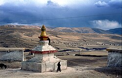Tibetan Buddhist stupa and houses outside the town of Ngawa, on the Tibetan Plateau.