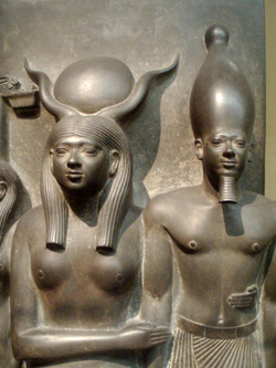 Close-up of a triad statue depicting the pharaoh Menkaura being held by the goddess Hathor