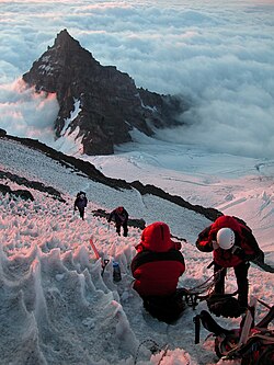 Climbers ascending Mount Rainier looking at Little Tahoma Peak, United States