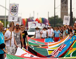 LGBT activists at Cologne Pride carrying a banner with the flags of over 70 countries where homosexuality is illegal