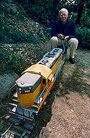 Johnston on his backyard railroad in 1993