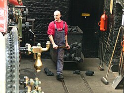 A fireman or stoker, sometimes called a "boilerman"