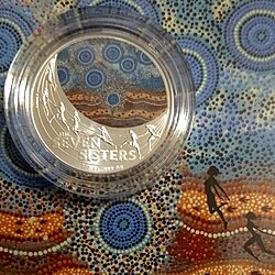 Commemorative silver one dollar coin issued in 2020 by the Royal Australian Mint - on the reverse, the Seven Sisters (Pleiades) are represented as they are portrayed in an ancient story of Australian Indigenous tradition.[30]