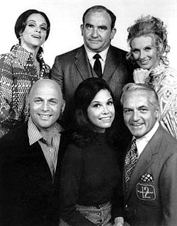 The original cast of The Mary Tyler Moore Show (1970)Top: Valerie Harper (Rhoda), Ed Asner (Lou Grant), Cloris Leachman (Phyllis). Bottom: Gavin MacLeod (Murray), Moore, Ted Knight (Ted)