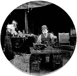 Charles Kayser of the Edison lab seated behind the Kinetograph.[17] Portability was not among the camera's virtues.